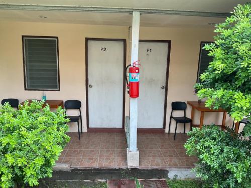 a red fire hydrant in front of a house at Go Gear Travel & Bungalow in Krabi town