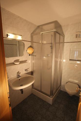 a bathroom with a shower and a sink and a toilet at Haus Helga in Kappl