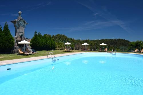 a large swimming pool with a tower in the background at Pousada de Viana do Castelo in Viana do Castelo