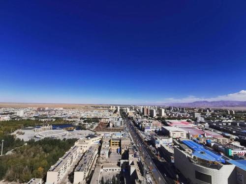 an aerial view of a city with buildings at James Joyce Coffetel Golmud Huaxing Plaza Branch in Golmud