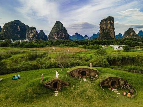 an aerial view of a field with mountains in the background at 桂林阳朔良宿 LS Hotel Liangsu Yangshuo in Gaotian