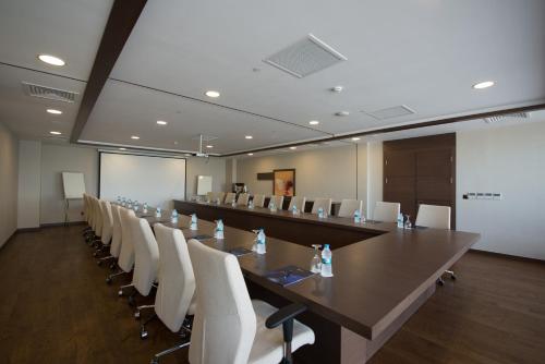 a large conference room with a long table and white chairs at Radisson Blu Hotel, Ordu in Ordu