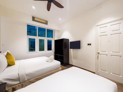 a bedroom with two beds and a window at Sujet Beach Hotel and Apartment Danang by Haviland in Da Nang