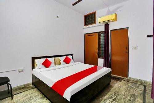 a bedroom with a large bed with red pillows at Hotel O Hotel Royal Palace in Meerut