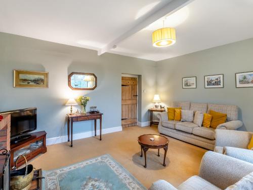 a living room with a couch and a tv at Snowshill in Alnwick