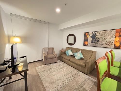 a living room with a couch and a chair at Glamorous KTown Boutique Residences with Rooftop view in Los Angeles