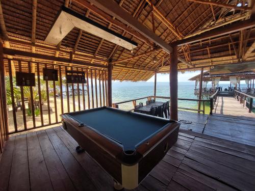 a pool table in a room with a view of the ocean at Siuri Cottages & Restaurant in Tokaimbu