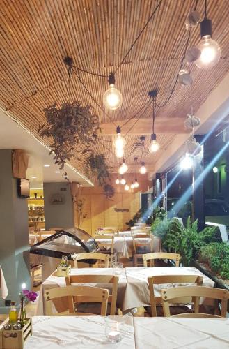 a restaurant with tables and chairs and lights at Atlantis Boutique City Hotel in Rhodes Town