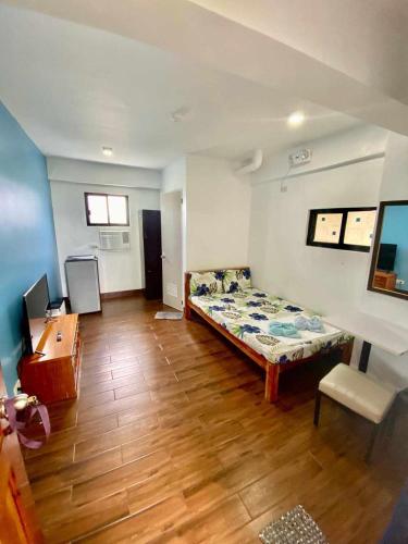 a room with a bed and a desk in it at FFG EDEN PRIVATE RESORT Moalboal in Cansojong