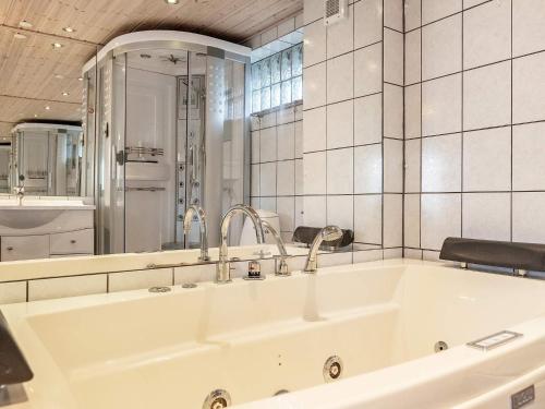 a large white bath tub in a bathroom at 4 person holiday home in Middelfart-By Traum in Middelfart