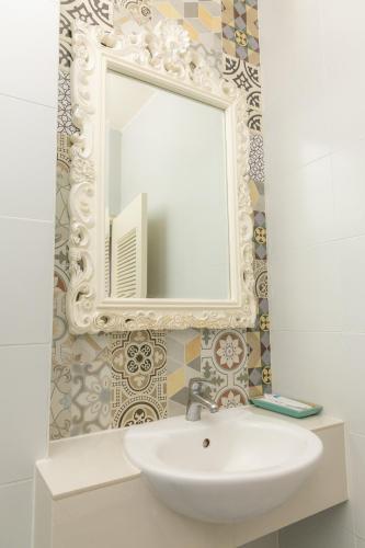 a bathroom with a sink and a mirror at Rasa Boutique Hotel Chiang Rai in Chiang Rai