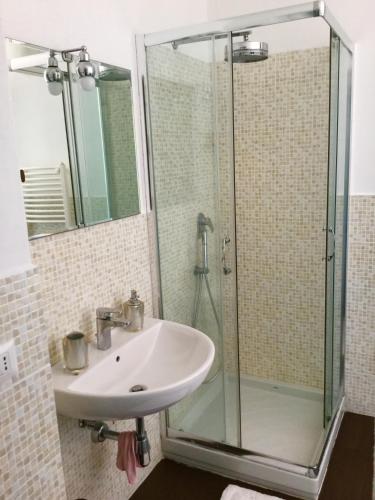 a bathroom with a sink and a shower at Villa Gandamar in Santa Teresa Gallura