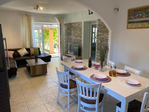 a kitchen and living room with a table and chairs at Holiday Home in Lisicic with Pool in Lisičići