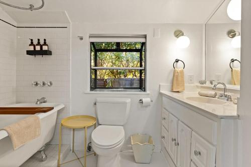 a bathroom with a toilet and a tub and a sink at Topanga Garden Paradise 1BR 1BA in the Heart of PO Tract in Topanga