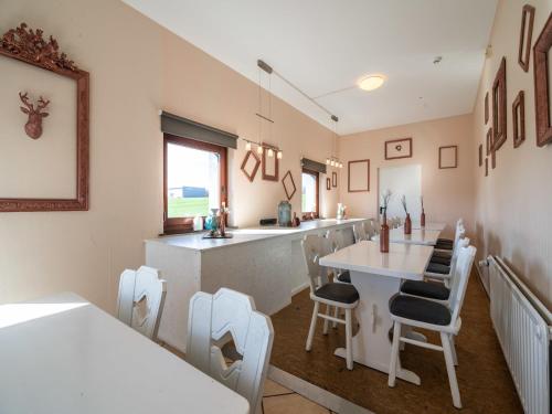 a kitchen with a counter and a table and chairs at Gouvy Getaway holiday home in Gouvy