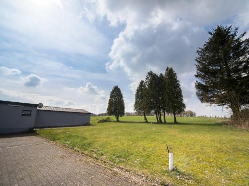 a large field with trees and a building and trees at Gouvy Getaway holiday home in Gouvy