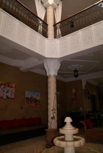 a large room with a large white column in a building at Riad Les Jardins de Tafraoute in Foum Mharech