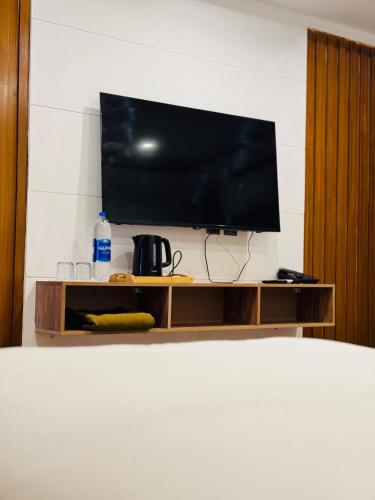 a flat screen tv sitting on top of a tv stand at Al Noor Starlet Hotel in Skardu