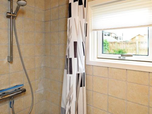 a shower curtain in a bathroom with a window at 6 person holiday home in Brenderup Fyn-By Traum in Vedelshave
