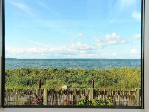 a view of the ocean from a fence at 6 person holiday home in Brenderup Fyn-By Traum in Vedelshave