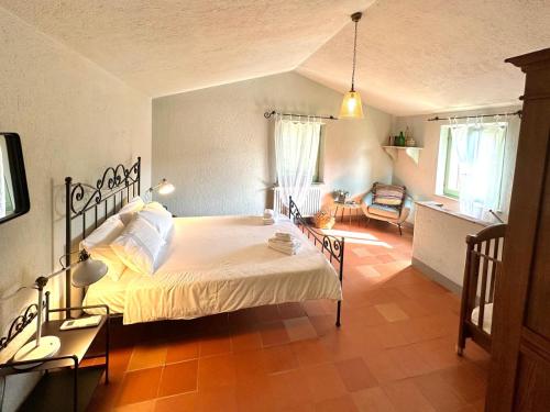 a bedroom with a large bed in a room at Casale Armonia in Massa Martana