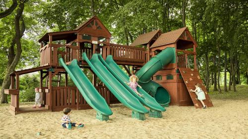 a playground with a slide in the sand at Hotel Aubrecht Country Spa Resort in Przechlewo