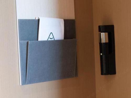 a box hanging on a wall with some items at Atour Hotel Jinan Tangyan Century Avenue in Jinan