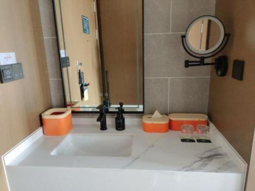 a bathroom counter with a sink and a mirror at Atour Hotel Jinan Tangyan Century Avenue in Jinan