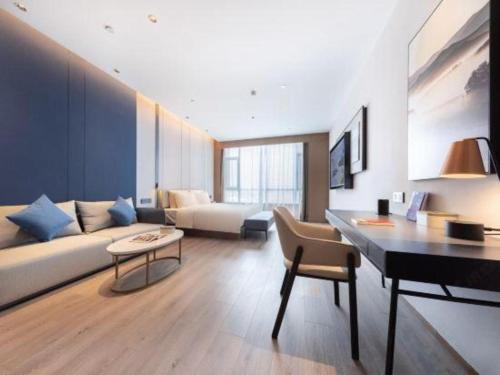 a living room with a couch and a piano at Atour Hotel Jinan Tangyan Century Avenue in Jinan