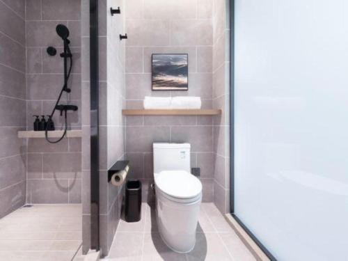 a bathroom with a toilet and a shower at Atour Hotel Jinan Tangyan Century Avenue in Jinan