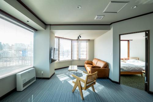 a living room with a couch and a bed at Cise Kawakami1 in Kushiro