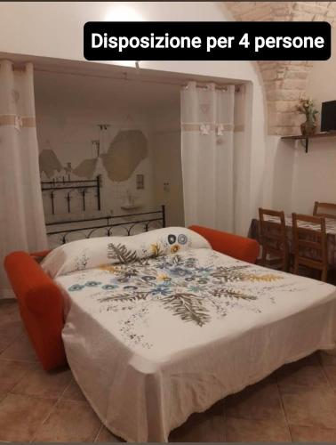 a bedroom with a bed with a white comforter at Soggiornare In Centro in Alberobello