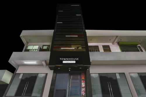 a tall building with a tokyo house sign on it at Super Townhouse Jagatpura Railway Station Formerly Hotel Buddhi in Jaipur