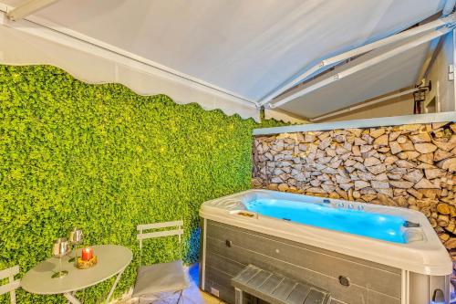 a bathroom with a tub and a green wall at Blue Mountain Guesthouse by Seablue in Arachova
