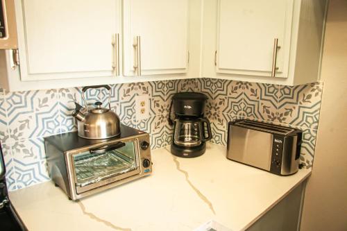 a kitchen counter with a microwave and a toaster oven at Large Pool & Patio Cozy Single Story Family House in Las Vegas