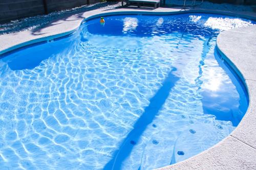 a swimming pool with blue water at Large Pool & Patio Cozy Single Story Family House in Las Vegas