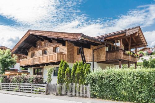 a wooden house with a wooden roof at Apartchalet Almliebe in Maria Alm am Steinernen Meer