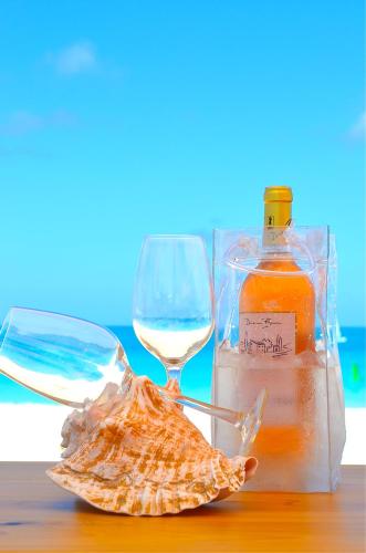 a bottle of wine and a glass on a table at West Bay Club in Grace Bay