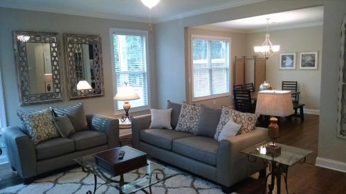 a living room with a couch and a table at Peachtree TownHome in Peachtree City