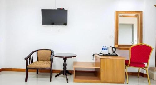 a room with two chairs and a desk and a mirror at Thatphanom View Hotel Nakhon in Nakhon Phanom