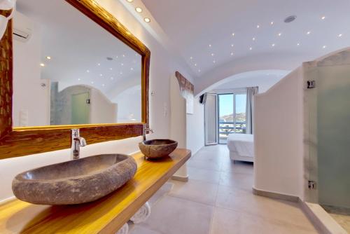 
a bathroom with two sinks and a large mirror at Ibiscus Boutique in Mikonos
