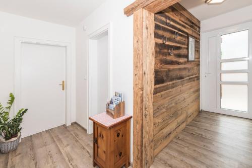 a sliding barn door in a living room with wood at Apartchalet Almliebe in Maria Alm am Steinernen Meer