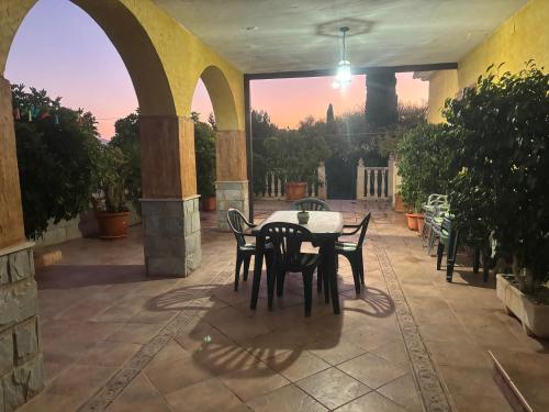 a table and chairs on a patio with a view at Alojamiento rural Villa Carmen in Mula