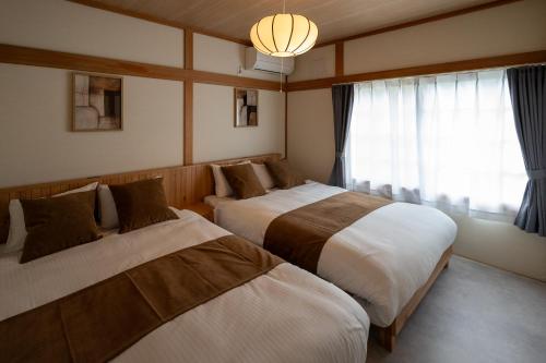 Ένα ή περισσότερα κρεβάτια σε δωμάτιο στο Furano Harmony House
