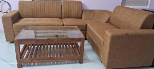 a couch and a coffee table in a living room at Bluebell Shores -Cozy Stay Near Varkala Beach in Varkala