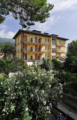 a yellow apartment building with flowers in front of it at Hotel Villa Adriana in Monterosso al Mare