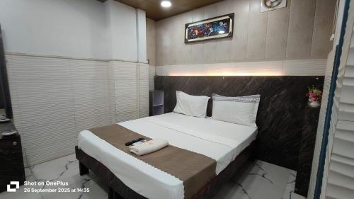 a bedroom with a bed with a phone on it at Hotel Revive By The Premium Villa in New Delhi
