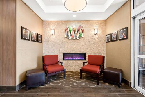 a waiting room with two chairs and a tv at Comfort Suites New Orleans East in New Orleans