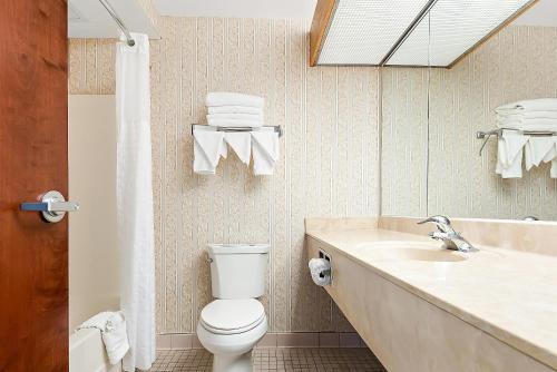 a bathroom with a toilet and a sink at Comfort Suites New Orleans East in New Orleans