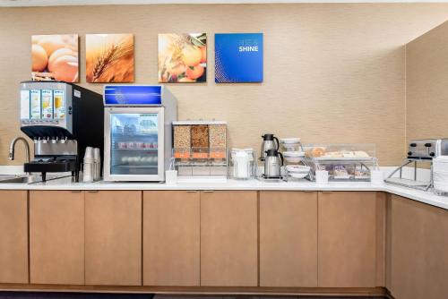 a kitchen with a counter top with a coffee maker at Comfort Suites New Orleans East in New Orleans